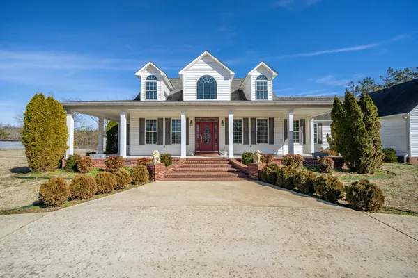 a living room with furniture and a book shelf