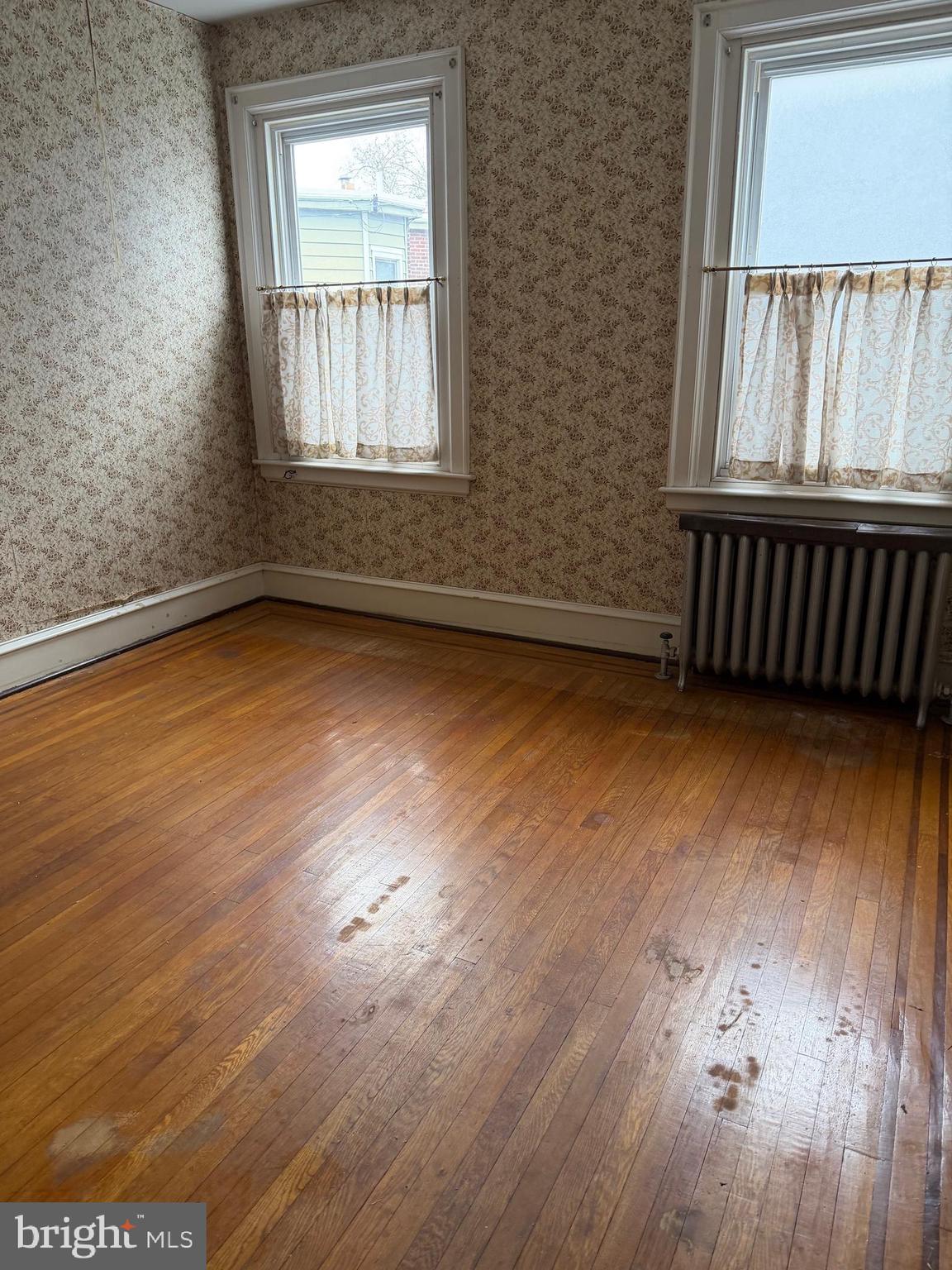 4640 Adams Avenue Philadelphia, PA 19124 - Photo 26 of 34 an empty room with wooden floor and windows