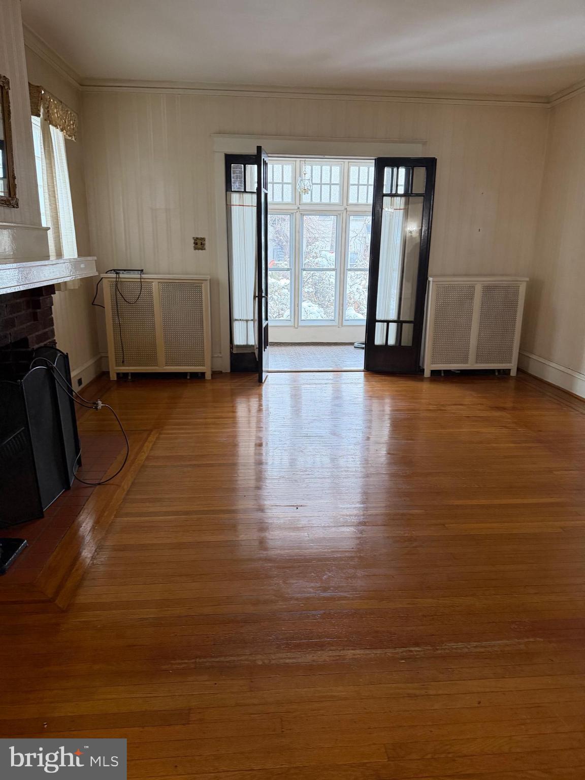4640 Adams Avenue Philadelphia, PA 19124 - Photo 31 of 34 a view of an empty room with a window and wooden floor