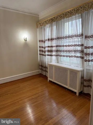 a kitchen with kitchen island wooden floor and window