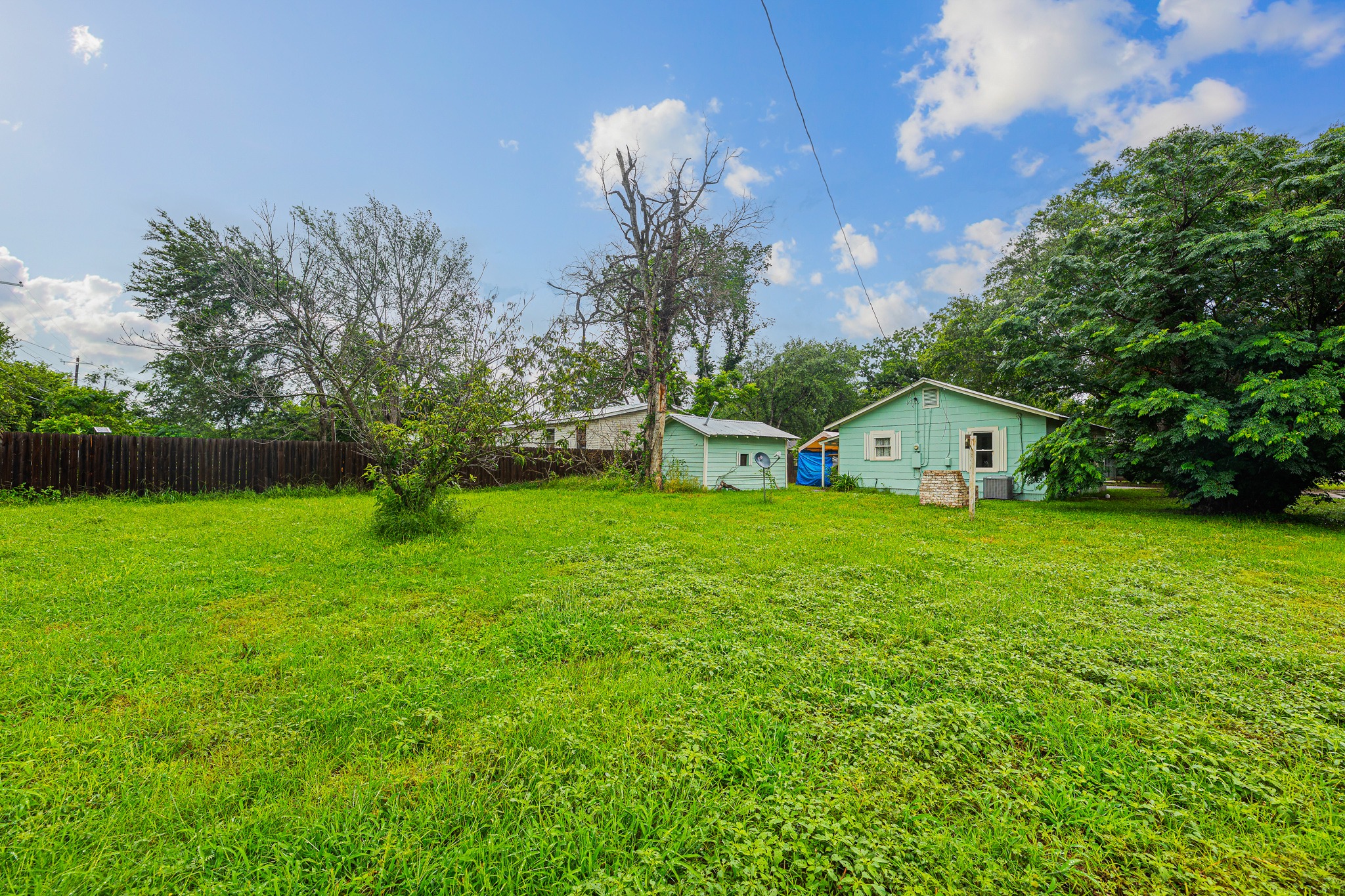 322 Blanco Avenue Luling, TX 78648 - Photo 18 of 20 A spacious backyard with vibrant green grass, ripe for outdoor enjoyment and potential expansion.