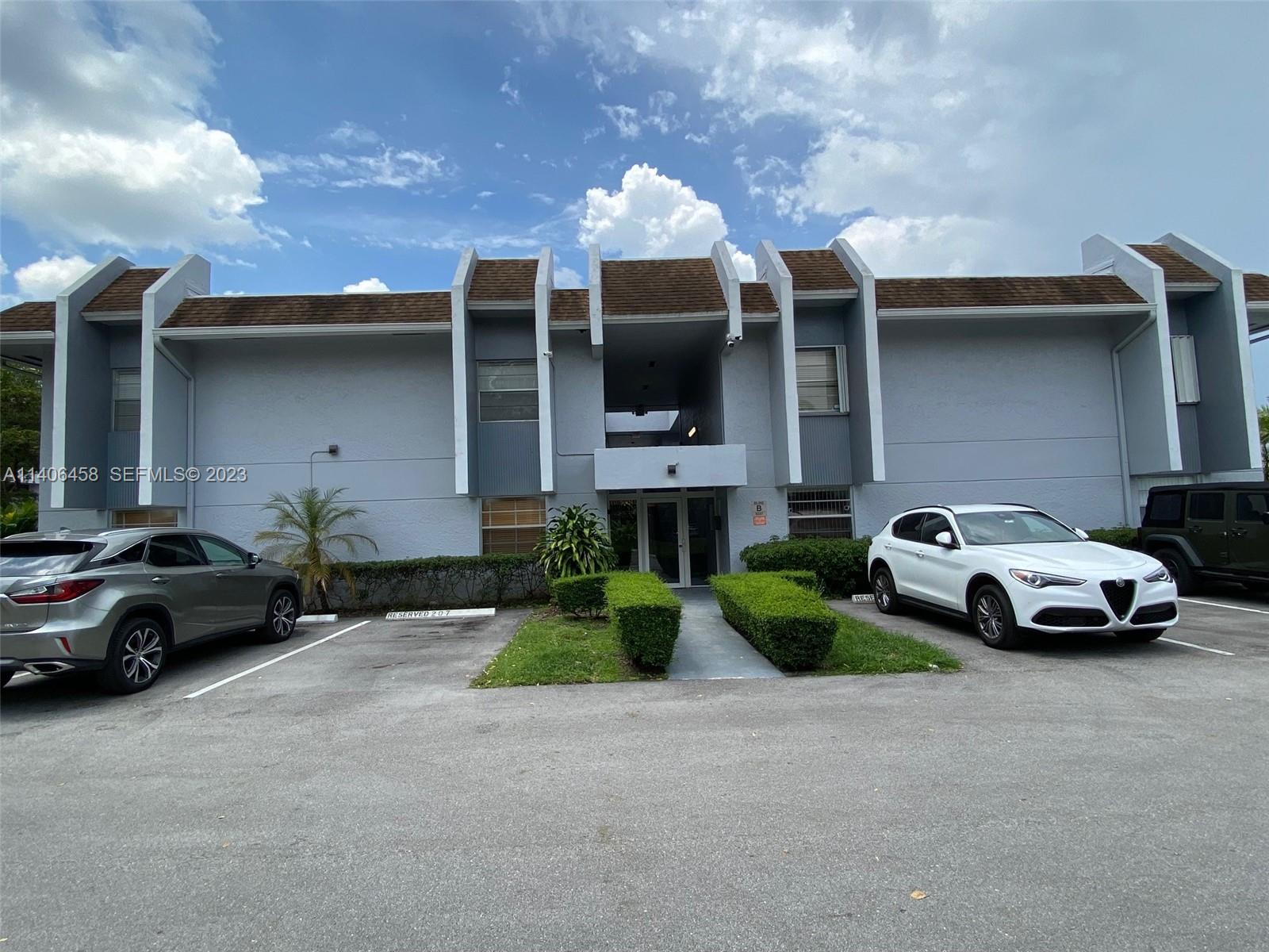 9227 Southwest 87th Avenue, Unit B7 Miami, FL 33176 - Photo 1 of 21 a view of a car parked in front of a building