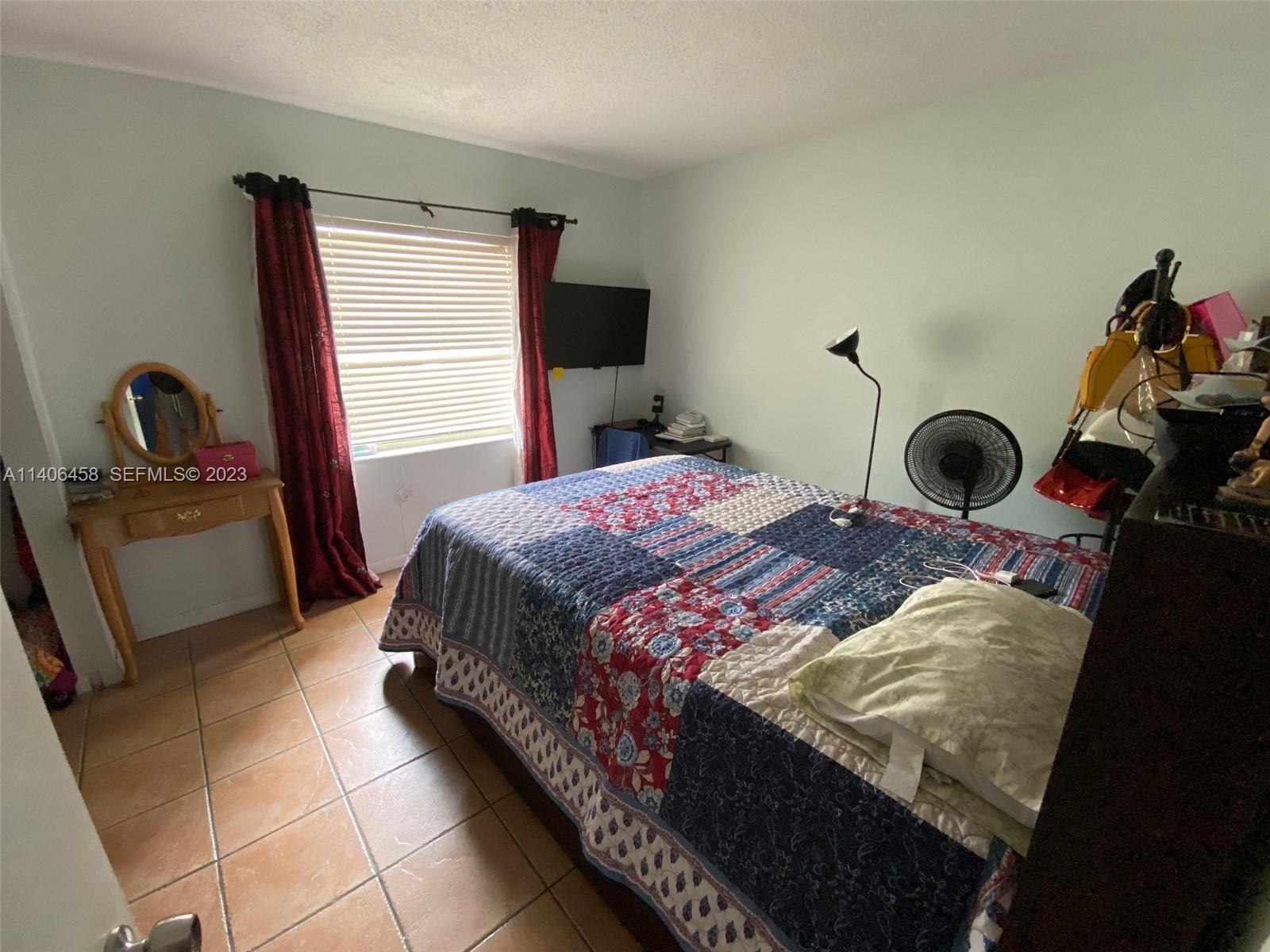 9227 Southwest 87th Avenue, Unit B7 Miami, FL 33176 - Photo 11 of 21 a bedroom with a bed and a window