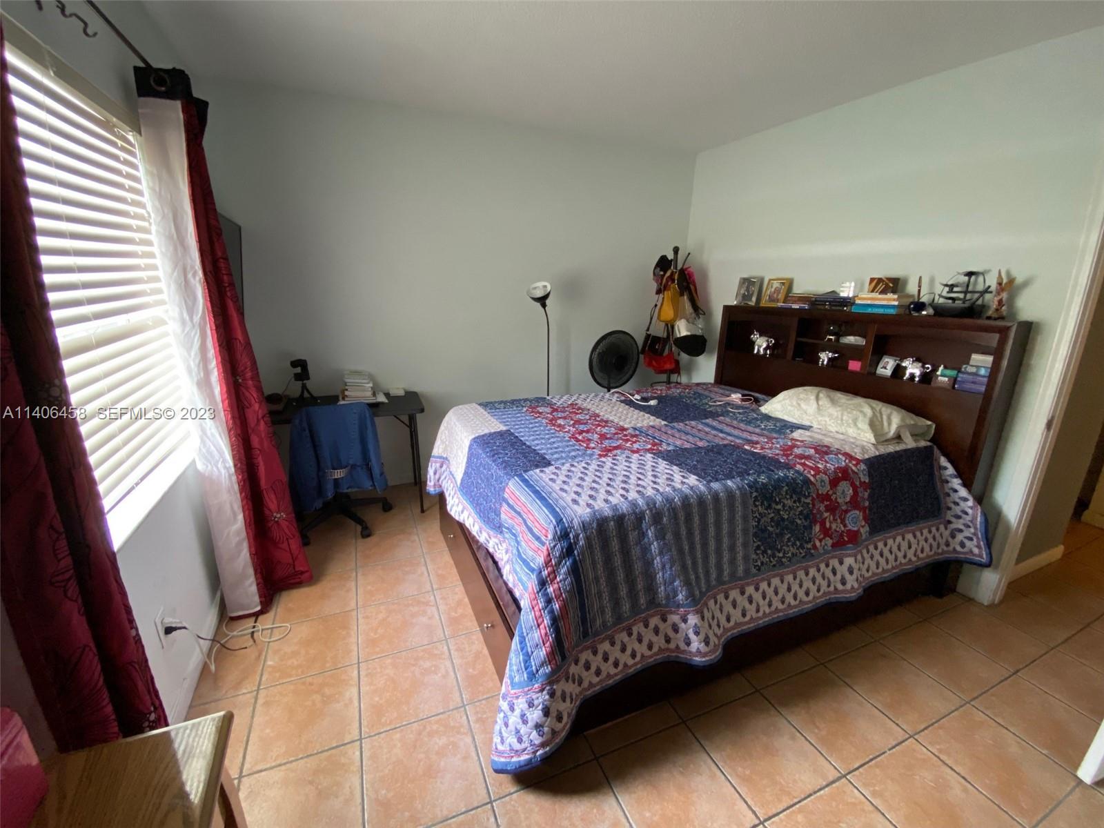 9227 Southwest 87th Avenue, Unit B7 Miami, FL 33176 - Photo 12 of 21 a bedroom with a bed and dresser