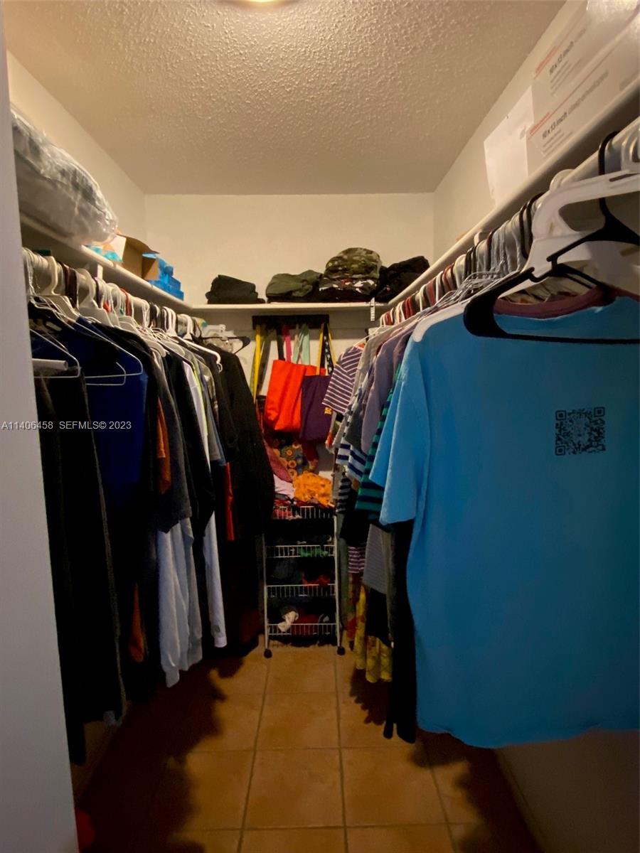 9227 Southwest 87th Avenue, Unit B7 Miami, FL 33176 - Photo 15 of 21 a view of walk in closet with clothes and shoes