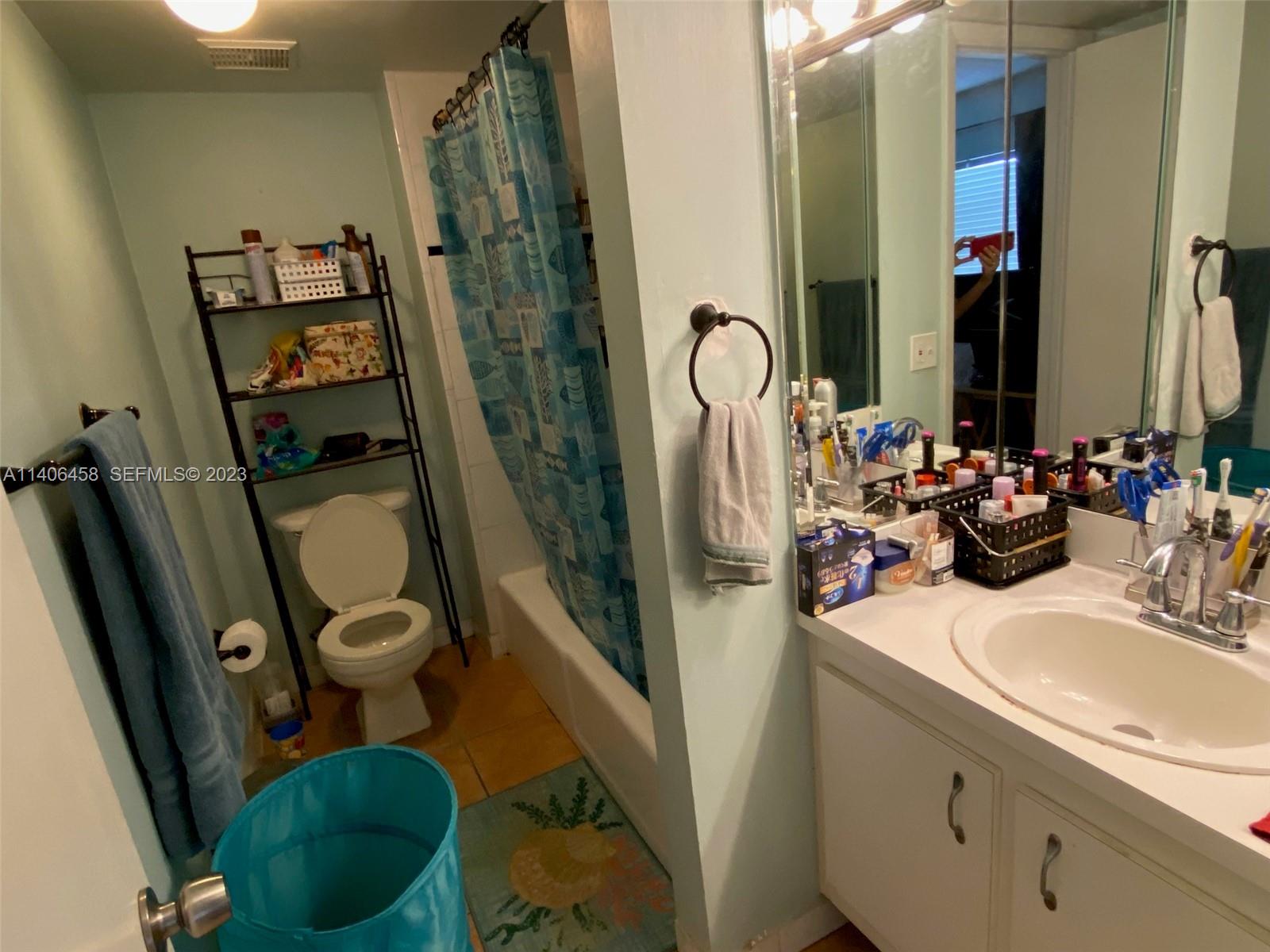 9227 Southwest 87th Avenue, Unit B7 Miami, FL 33176 - Photo 17 of 21 a bathroom with a sink a toilet a mirror and shower