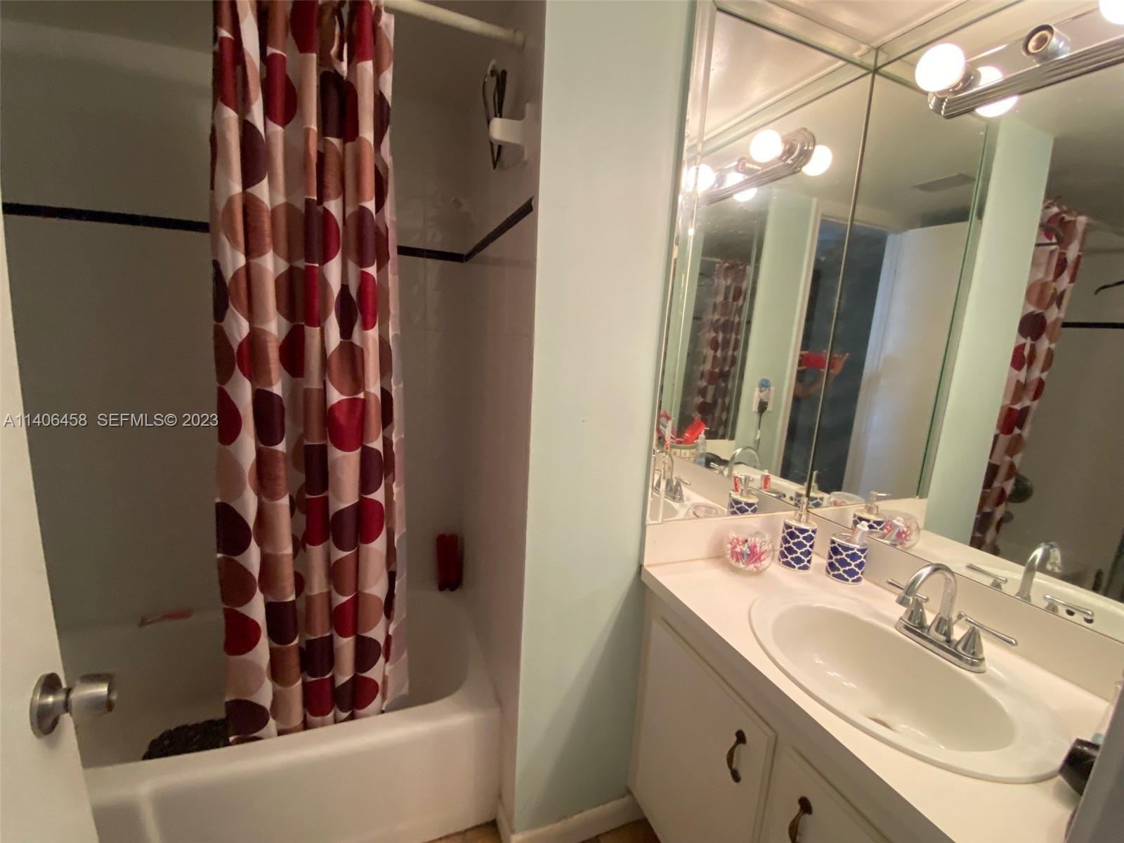 9227 Southwest 87th Avenue, Unit B7 Miami, FL 33176 - Photo 18 of 21 a bathroom with a sink and a mirror