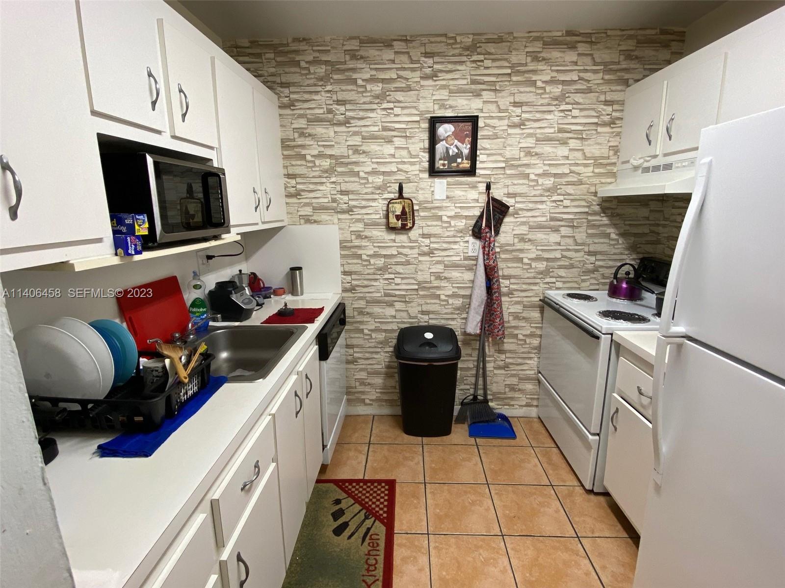 9227 Southwest 87th Avenue, Unit B7 Miami, FL 33176 - Photo 3 of 21 a kitchen with a stove and a microwave