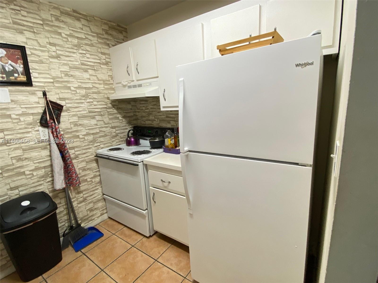 9227 Southwest 87th Avenue, Unit B7 Miami, FL 33176 - Photo 4 of 21 a white refrigerator freezer and a stove sitting inside of a kitchen