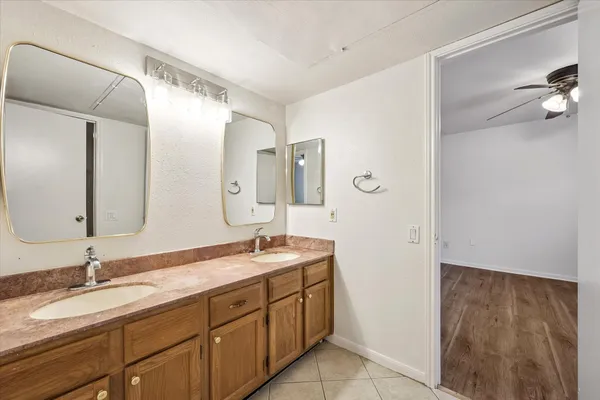 a bathroom with a granite countertop sink mirror and double