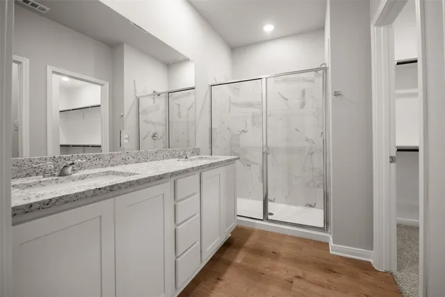 a kitchen with a sink and a stove with wooden floor