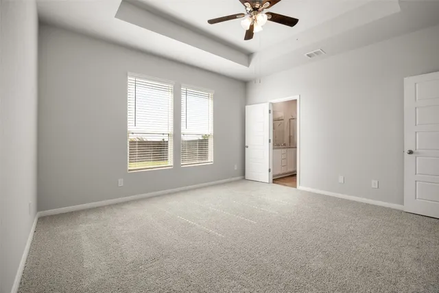 a bathroom with a granite countertop sink a toilet and shower