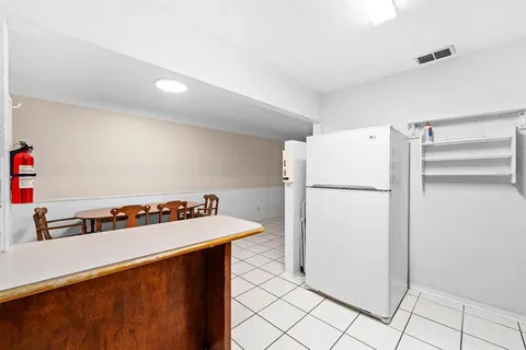 a kitchen with a refrigerator and a stove