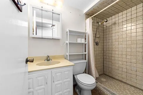 a bathroom with a sink toilet and shower