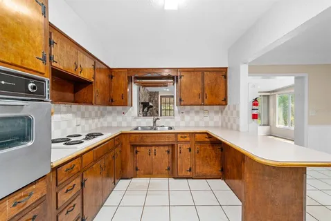 a kitchen with stainless steel appliances a sink stove top oven and cabinets