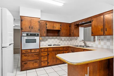 a kitchen with stainless steel appliances a sink cabinets and wooden floor