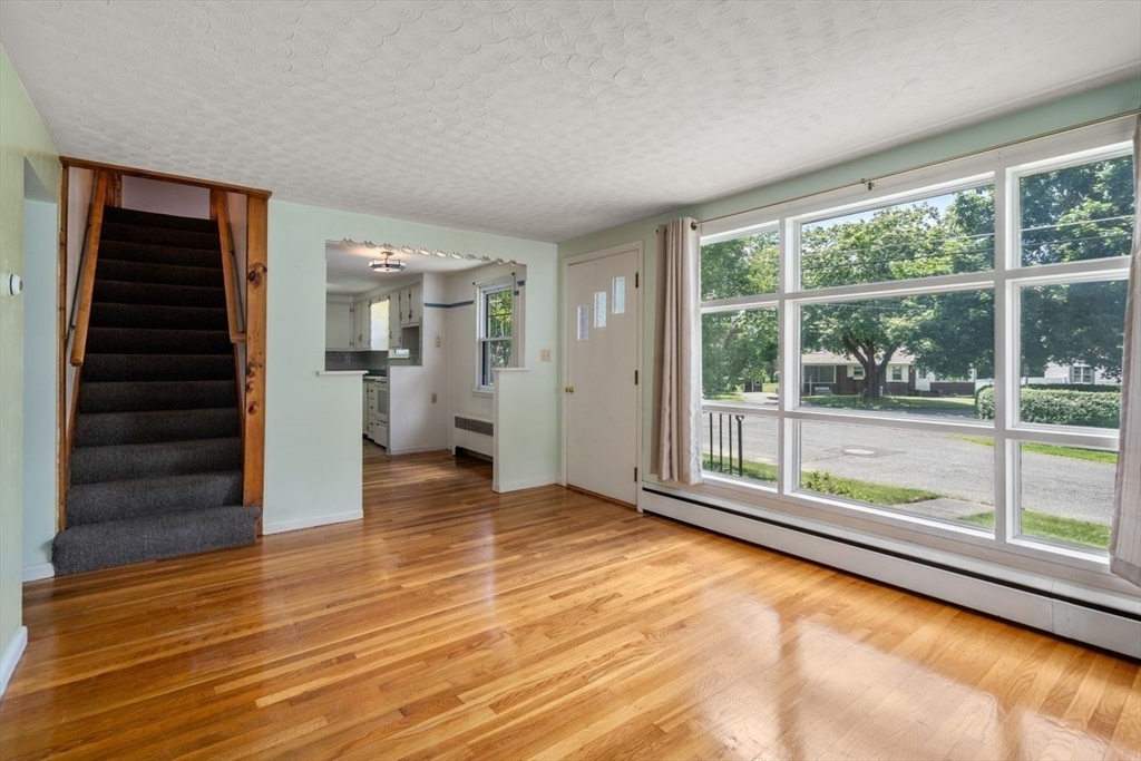 11 Gloucester Road Grafton, MA 01536 - Photo 12 of 38 a view of empty room with wooden floor and fan