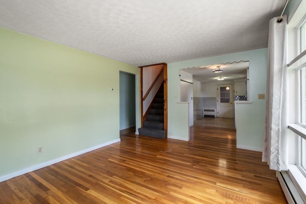 11 Gloucester Road Grafton, MA 01536 - Photo 13 of 38 a view of empty room with wooden floor and stairs