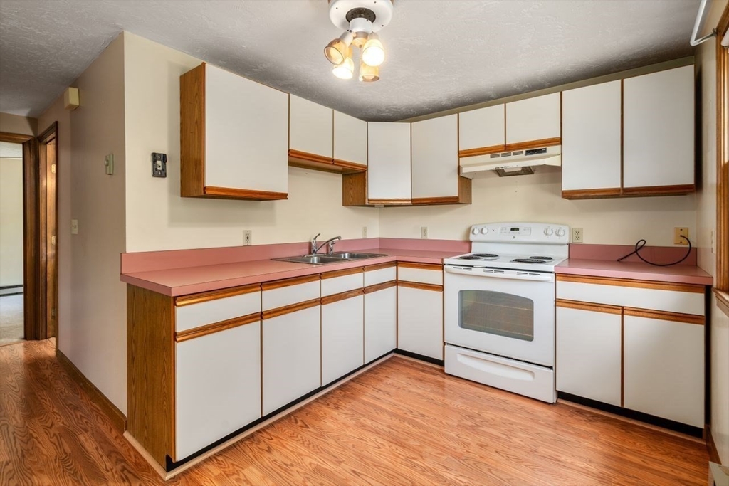11 Gloucester Road Grafton, MA 01536 - Photo 21 of 38 a kitchen with granite countertop a sink stainless steel appliances and cabinets