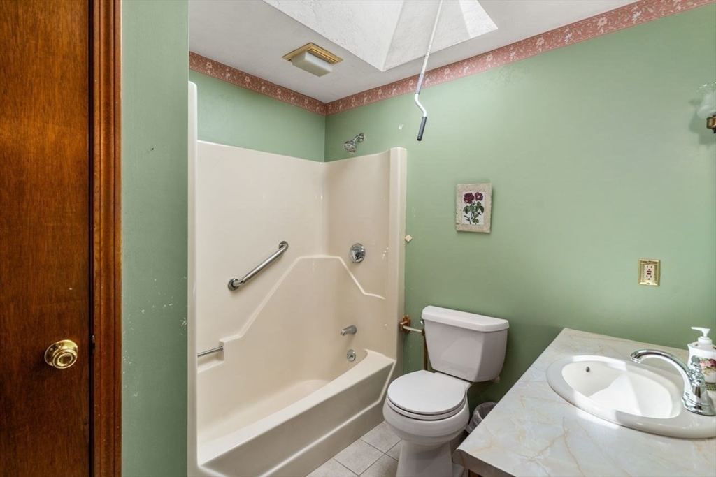 11 Gloucester Road Grafton, MA 01536 - Photo 27 of 38 a white toilet sitting next to a bath tub and a shower