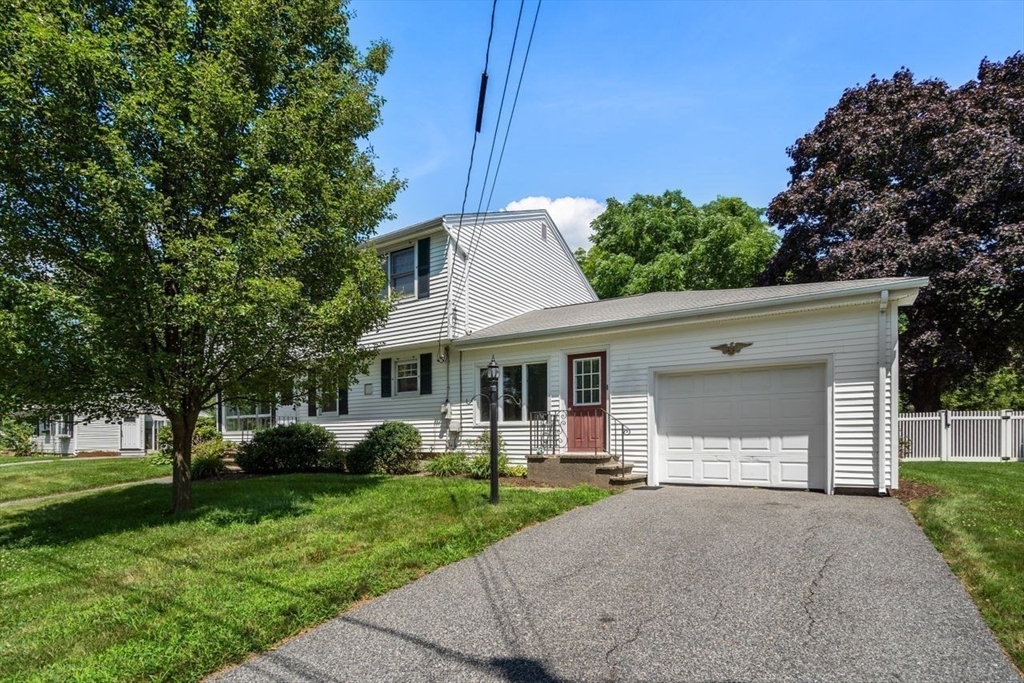 11 Gloucester Road Grafton, MA 01536 - Photo 32 of 38 a view of a white house with a yard plants and a large tree