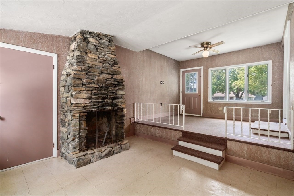 11 Gloucester Road Grafton, MA 01536 - Photo 5 of 38 a living room with furniture and a fireplace