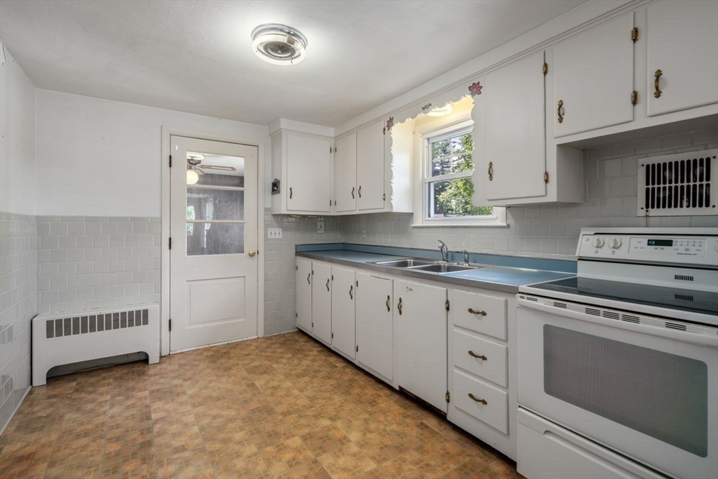 11 Gloucester Road Grafton, MA 01536 - Photo 7 of 38 a kitchen with granite countertop white cabinets and white appliances