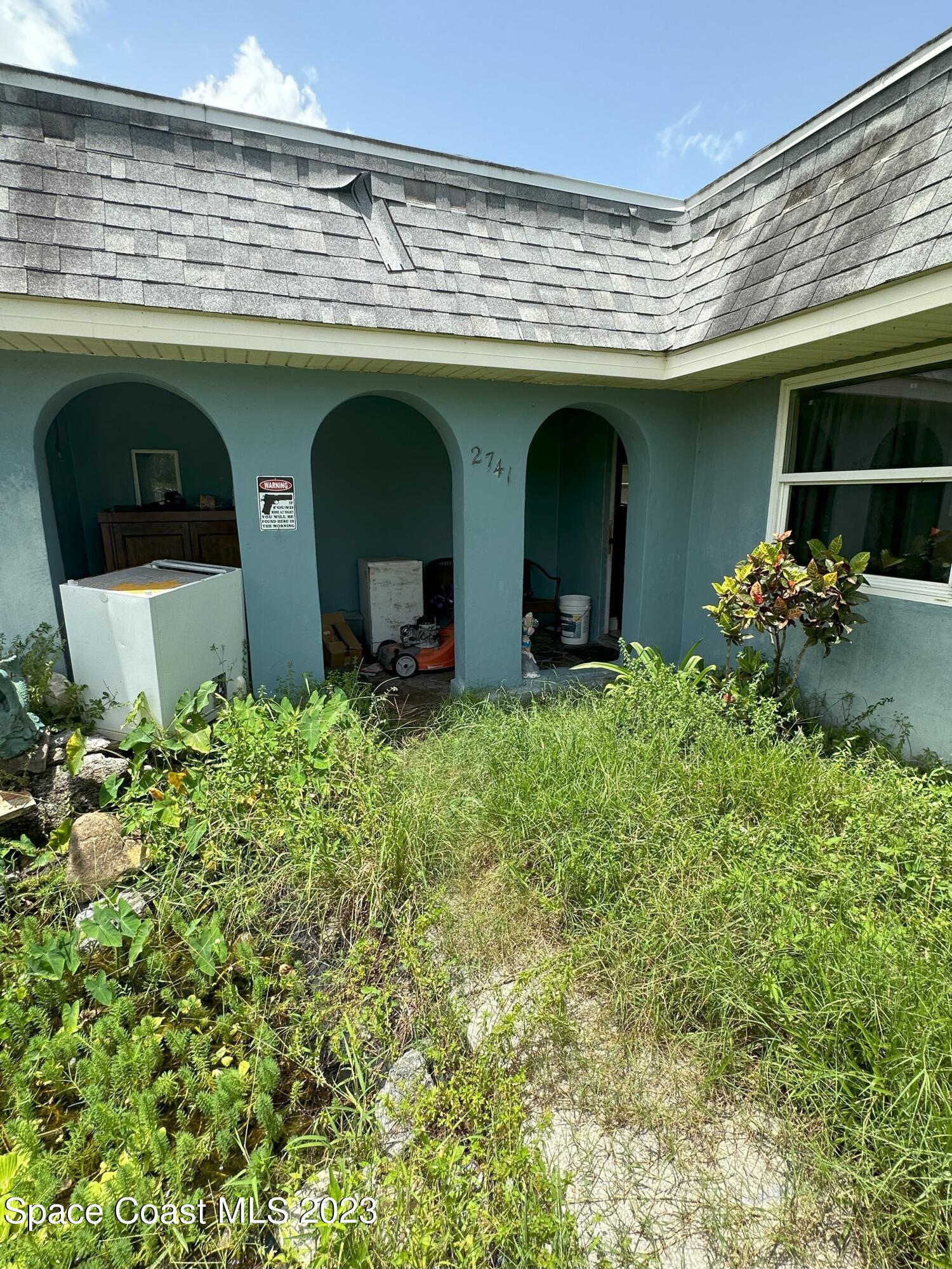 2741 Rhapsody Street Northeast Palm Bay, FL 32905 - Photo 10 of 15 Front Path