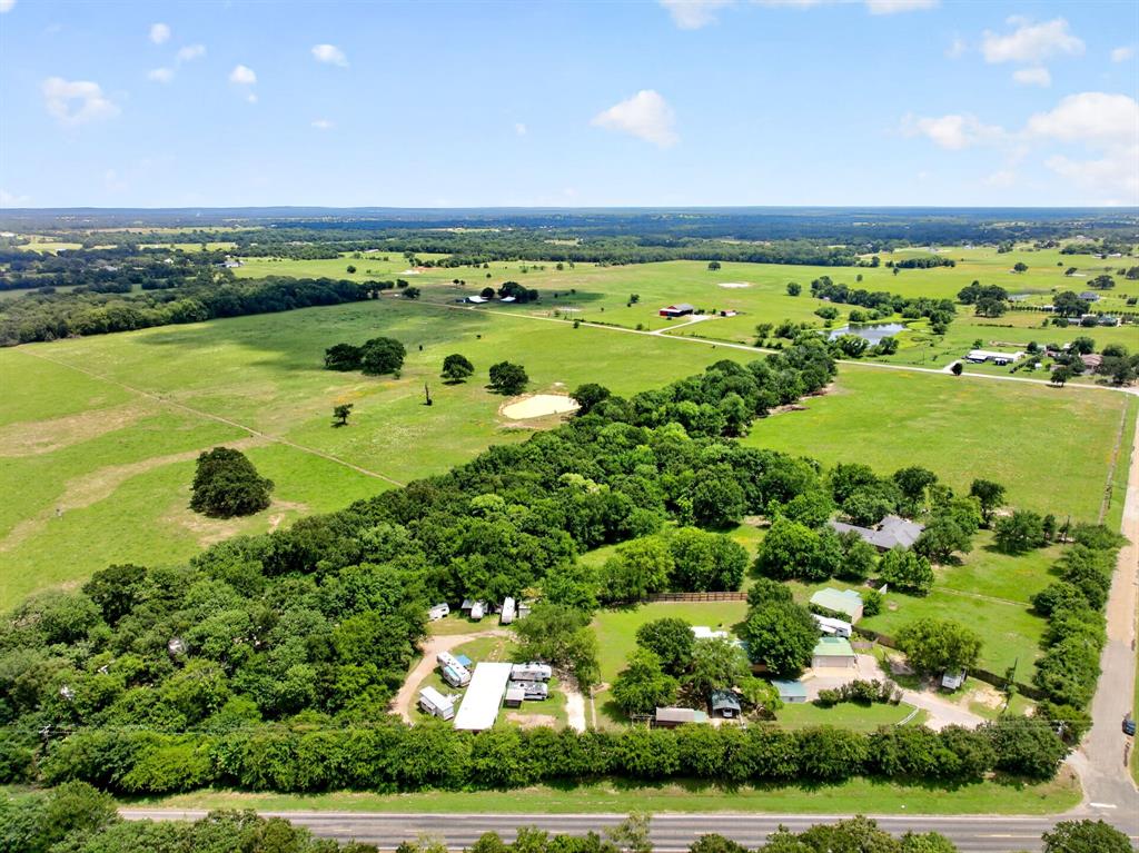 111 County Road 2806 Mabank, TX 75147 - Photo 27 of 34 Expansive acreage featuring mature trees, open fields, multiple structures, and paved road frontage