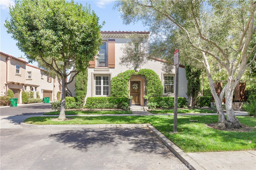78 Bower Tree Irvine, CA 92603 - Photo 1 of 25 a front view of a house with yard and green space