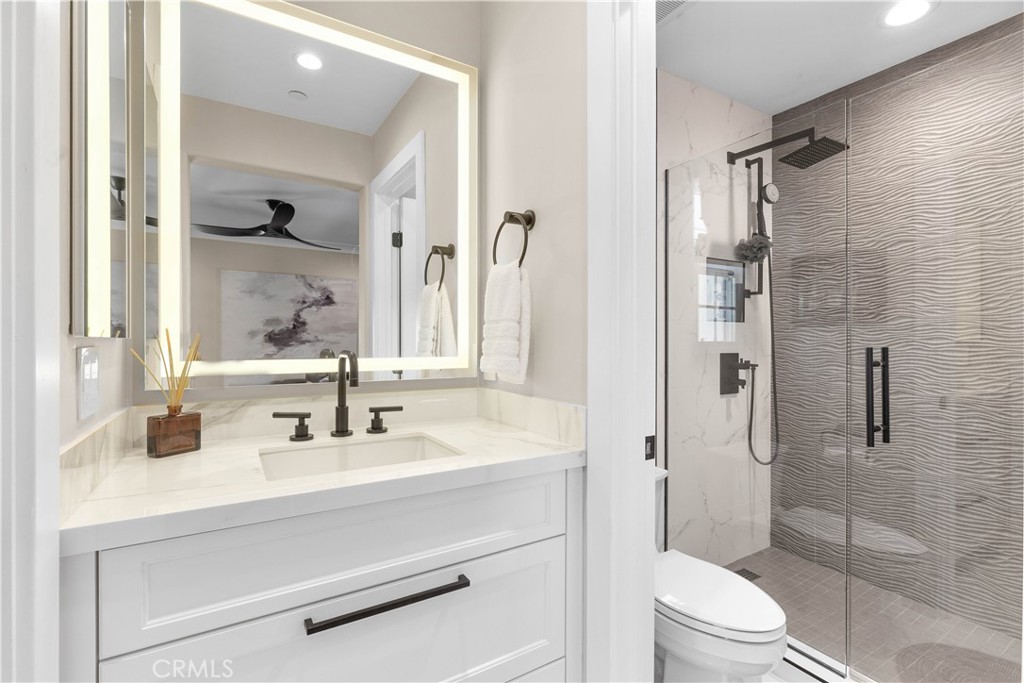 78 Bower Tree Irvine, CA 92603 - Photo 18 of 25 a bathroom with a sink toilet a mirror and shower