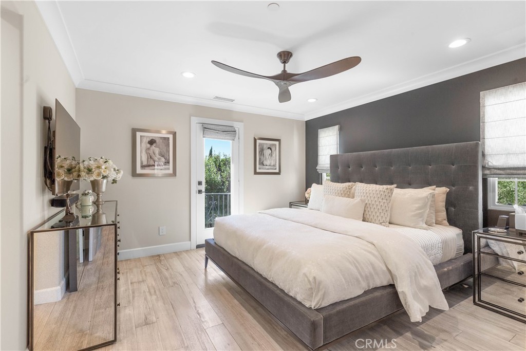 78 Bower Tree Irvine, CA 92603 - Photo 19 of 25 a bedroom with a large bed and a chandelier