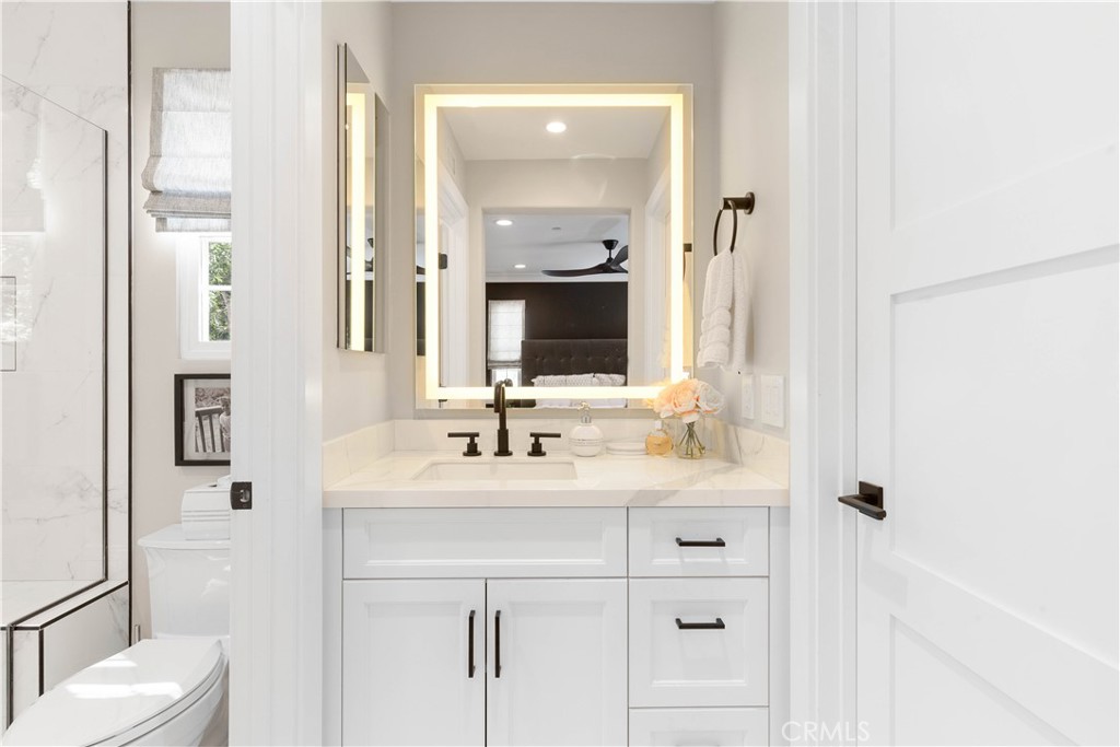 78 Bower Tree Irvine, CA 92603 - Photo 21 of 25 a bathroom with a sink vanity mirror and toilet