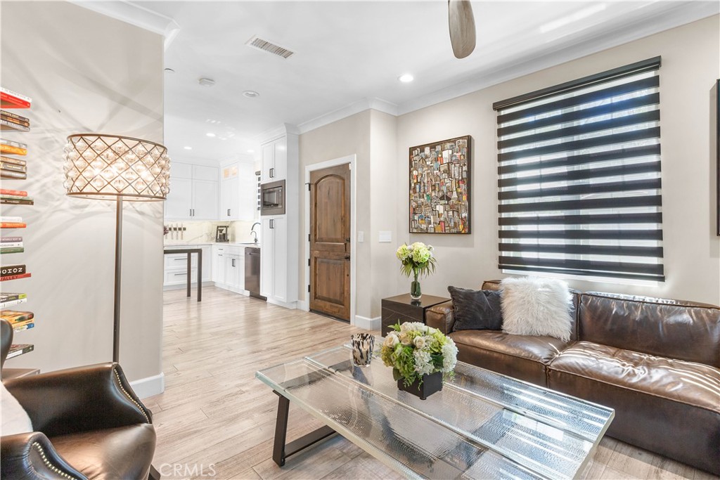 78 Bower Tree Irvine, CA 92603 - Photo 4 of 25 a living room with furniture and a chandelier