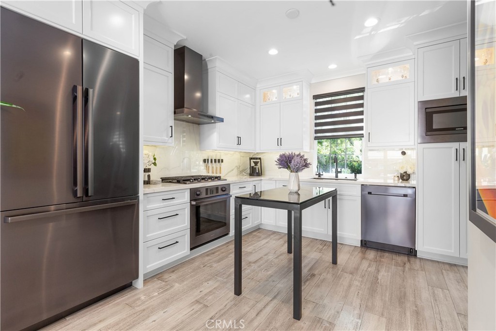 78 Bower Tree Irvine, CA 92603 - Photo 8 of 25 a kitchen with stainless steel appliances a refrigerator sink and microwave