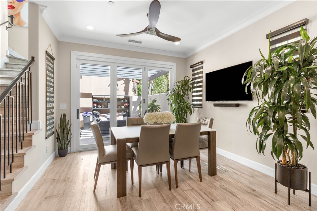 78 Bower Tree Irvine, CA 92603 - Photo 9 of 25 a dining room with furniture potted plants and wooden floor