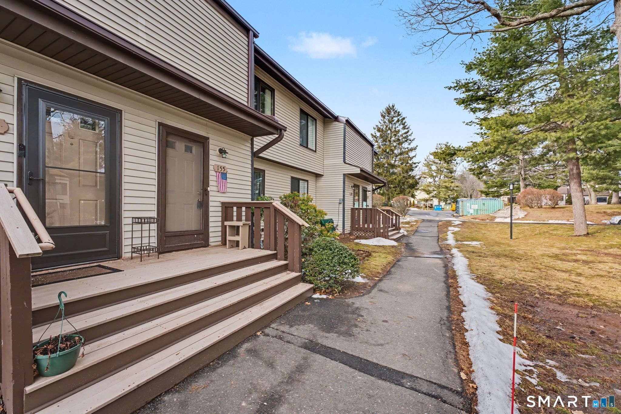 a view of a brick house with many windows next to a yard