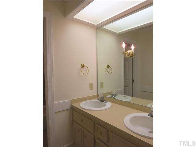 10012 Old Warden Road Raleigh, NC 27615 - Photo 20 of 25 View of the lg divided hall Bath w/dbl sinks, tile flr & tile tub/shower surround. Bathroom