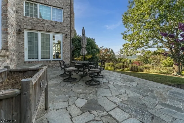 a view of a patio with table and chairs and potted plants