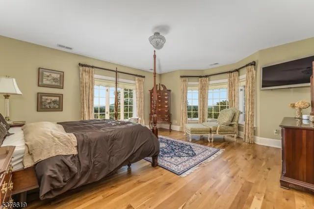 a bathroom with a bathtub shower sink mirror and toilet
