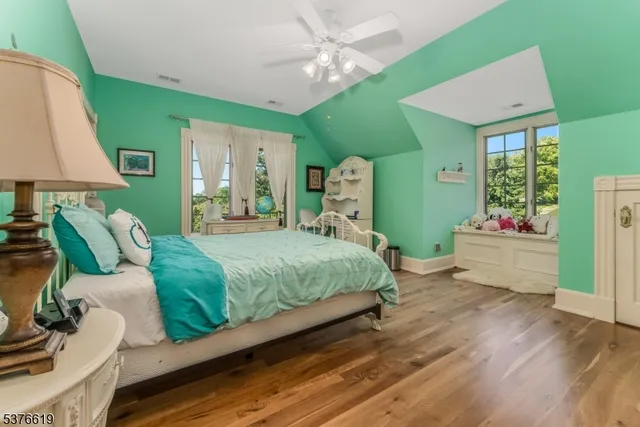 a bathroom with a granite countertop sink a mirror and a shower