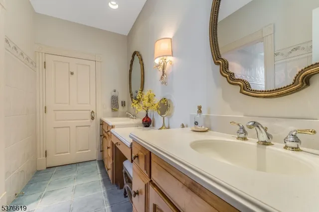 a bedroom with a bed and a potted plant on dresser