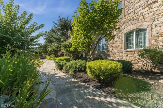 a view of a garden with a house