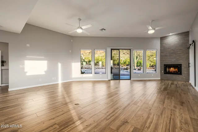 a bathroom with a sink a toilet a mirror and shower