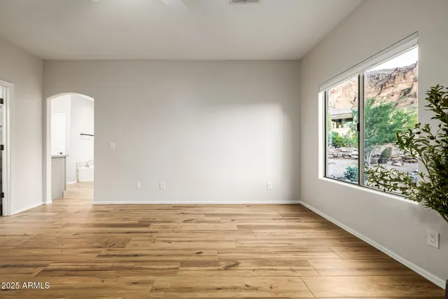a view of an empty room with a fireplace and a window