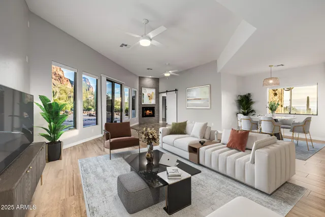 a view of an empty room with window and wooden floor
