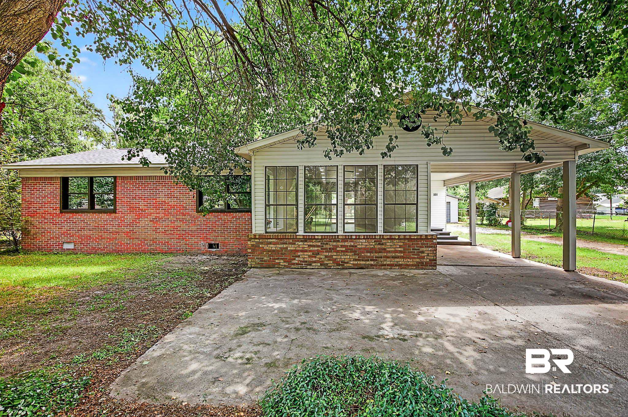101 Terry Avenue Brewton, AL 36426 - Photo 1 of 48 View of front of property featuring crawl space, brick siding, an attached carport, and driveway