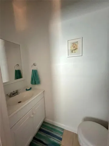 a bathroom with a sink toilet and mirror