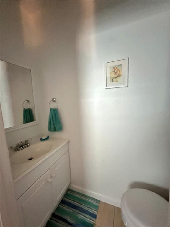 220 South 26th Street, Unit 3 Flagler Beach, FL 32136 - Photo 11 of 20 a bathroom with a sink toilet and mirror