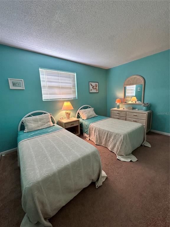 220 South 26th Street, Unit 3 Flagler Beach, FL 32136 - Photo 14 of 20 a bedroom with two beds and a window